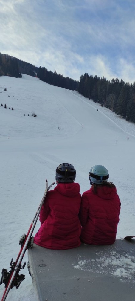 Foto: 2 Sch&uuml;lerinnen von hinten, die auf einen schneebedeckten Berg schauen
